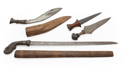 Lot 132 - A Malay sword, a kukri and two other North African daggers