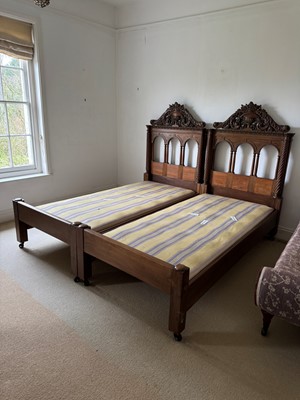 Lot 517 - A pair of carved walnut single beds