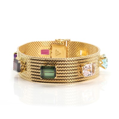 Lot 243 - A gold and multi-gem strap bracelet