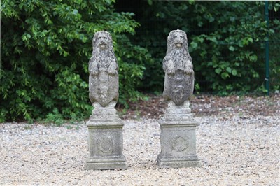 Lot 637 - A pair of composite stone armorial lions