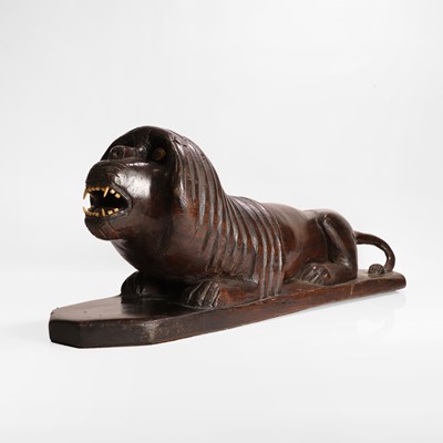 Lot 148 - A carved hardwood lion