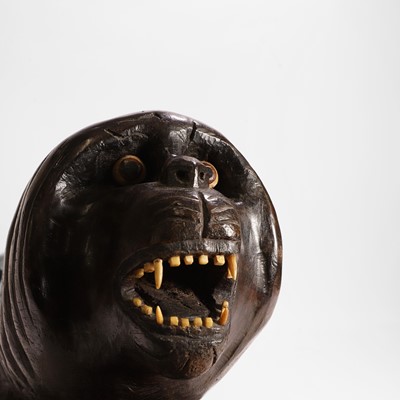 Lot 148 - A carved hardwood lion