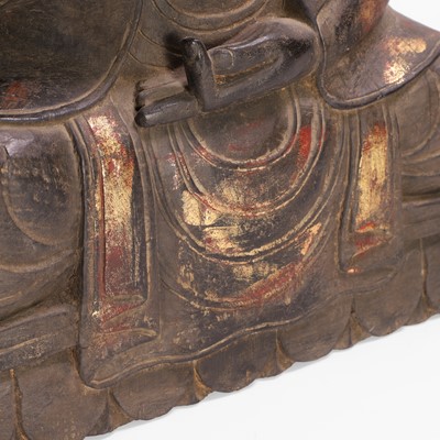 Lot 16 - A carved, gilt and polychrome-painted Buddha