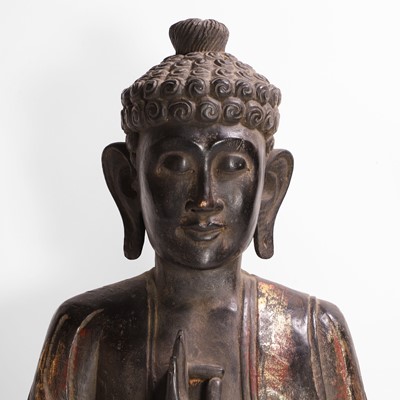 Lot 16 - A carved, gilt and polychrome-painted Buddha