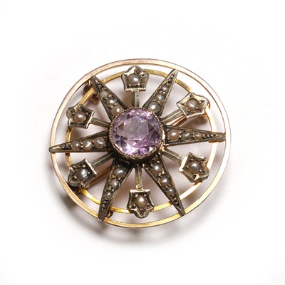 Lot 25 - An Edwardian amethyst and seed pearl starburst brooch/pendant
