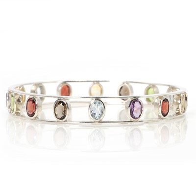 Lot 180 - A silver vari-coloured gemstone bangle