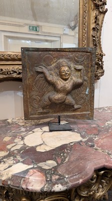 Lot 127 - A gilt-copper repoussé temple plaque