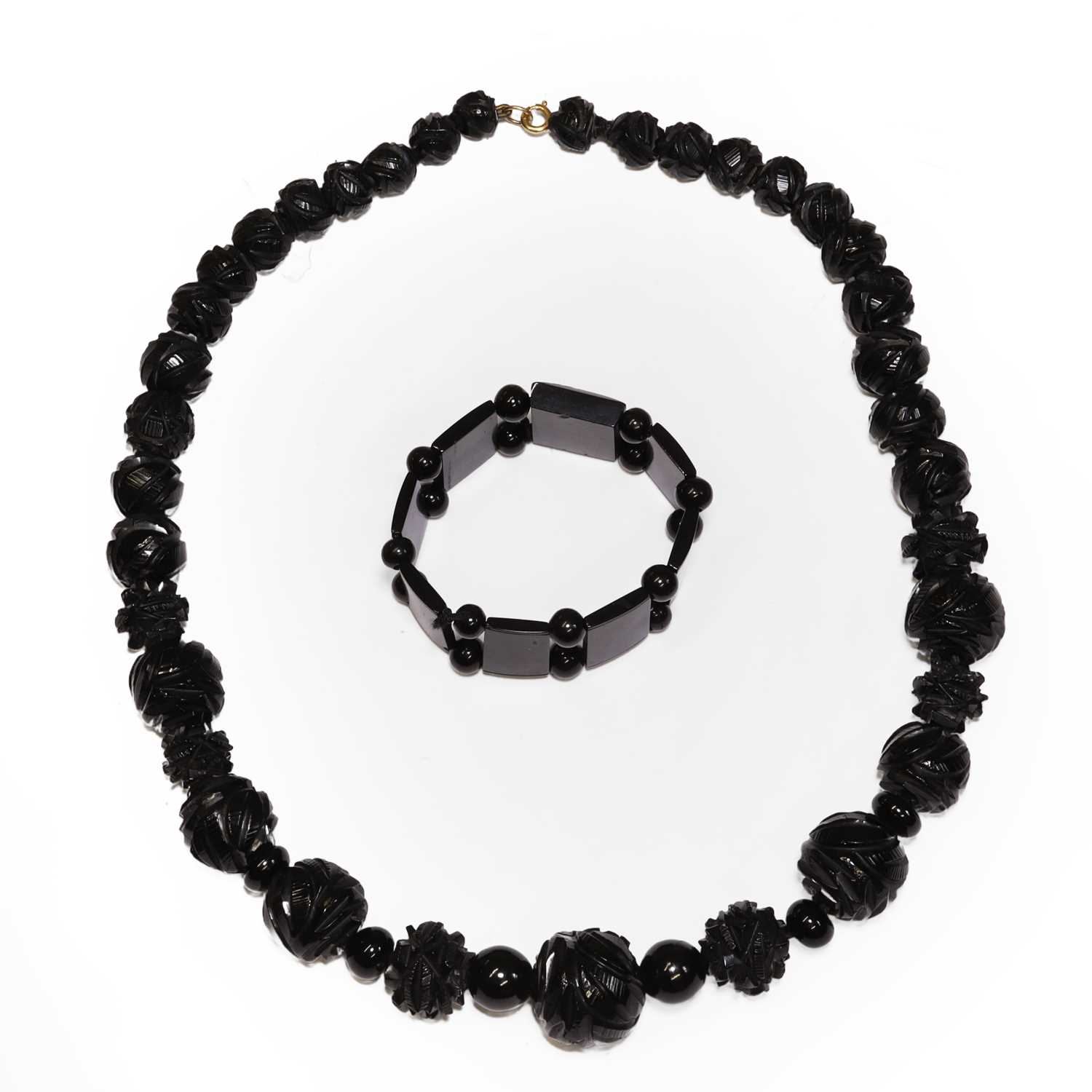 Lot 30 - A Victorian carved Whitby jet bead necklace and a bracelet