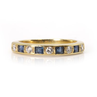 Lot 111 - An 18ct gold sapphire and diamond half eternity ring