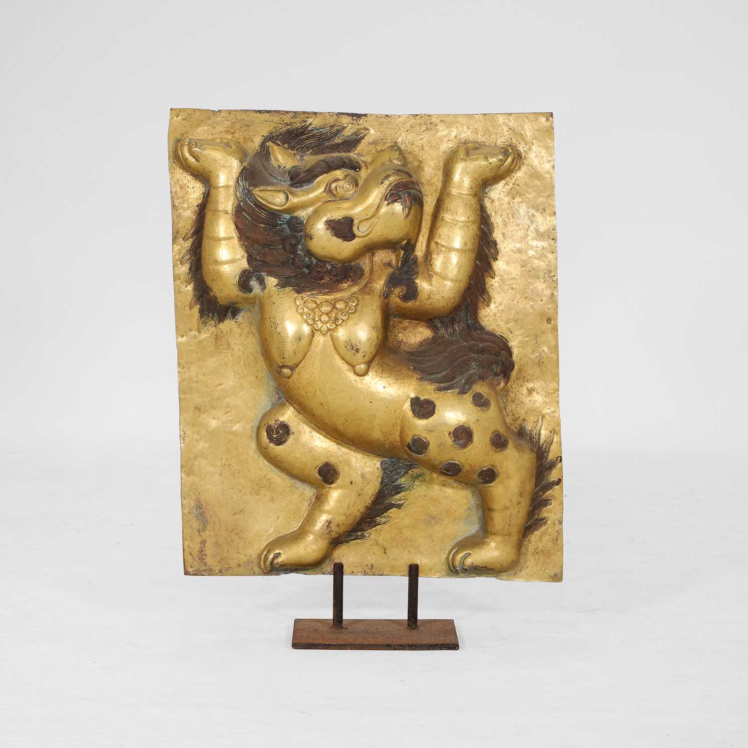 Lot 166 - A gilt-copper panel of a lion
