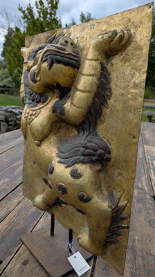 Lot 166 - A gilt-copper panel of a lion
