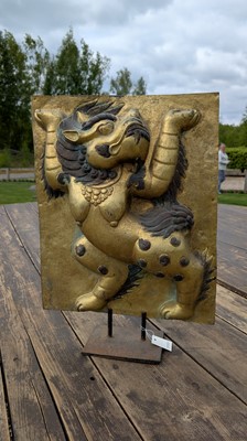 Lot 166 - A gilt-copper panel of a lion