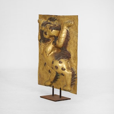 Lot 166 - A gilt-copper panel of a lion