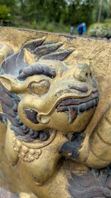 Lot 166 - A gilt-copper panel of a lion