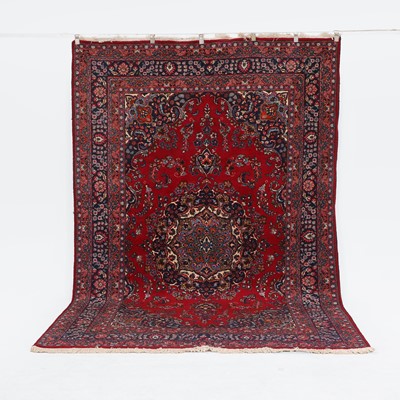 Lot 349 - A red-ground wool carpet