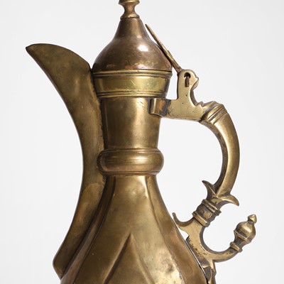 Lot 24 - A collection of four copper and brass ewers