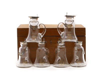Lot 64 - A set of six cased silver topped whiskey noggins