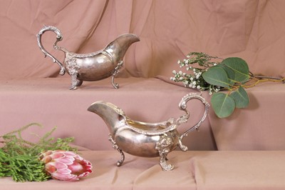 Lot 309 - A pair of George II cast silver sauce boats