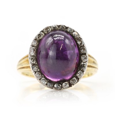 Lot 21 - An antique purple star sapphire and diamond ring