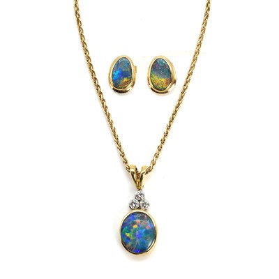 Lot 224 - An 18ct yellow and white gold black opal doublet and diamond pendant