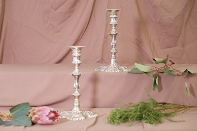 Lot 19 - A pair of George II cast silver candlesticks