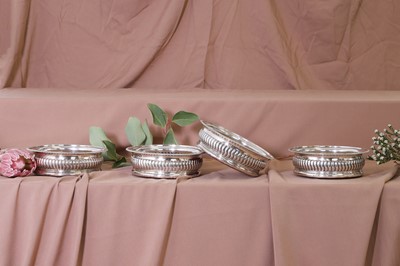 Lot 311 - A set of four George III silver wine coasters