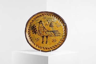 Lot 261 - A slipware glazed terracotta charger