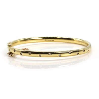 Lot 139 - An 18ct gold diamond bangle