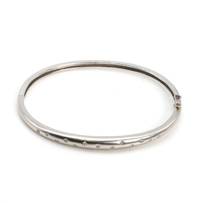 Lot 138 - A white gold diamond hinged bangle