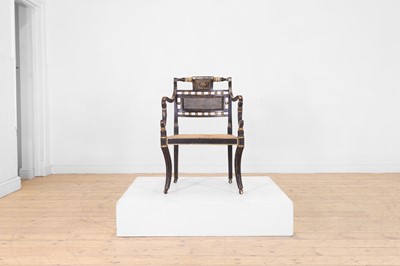Lot 595 - A Regency ebonised and parcel-gilt elbow chair