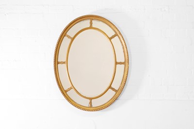 Lot 473 - A George III-style giltwood and gesso oval mirror