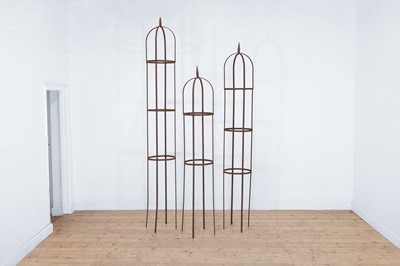 Lot 628 - A set of three metal garden obelisks