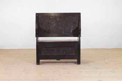 Lot 109 - A carved oak monk's bench