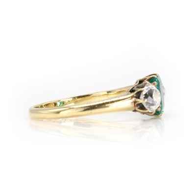 Lot 250 - An emerald and old cut diamond three stone ring