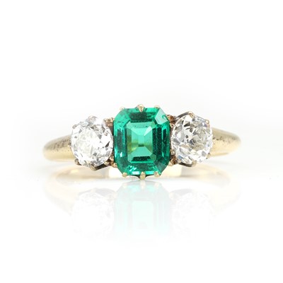 Lot 250 - An emerald and old cut diamond three stone ring
