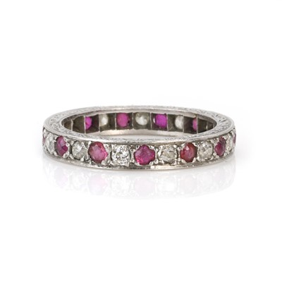 Lot 98 - A platinum ruby and diamond eternity ring