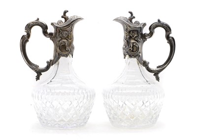 Lot 62 - A pair of silver-mounted glass claret jugs