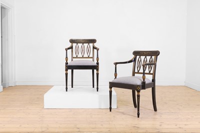 Lot 601 - A pair of Regency-style ebonised wooden elbow chairs