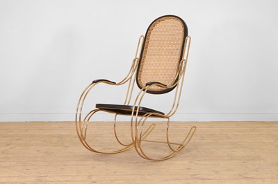 Lot 604 - A polished brass, ebonised and caned rocking chair in the style of Marcel Breuer