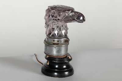 Lot 367 - A mauve crystal 'Tête d'Aigle' car mascot by René Lalique