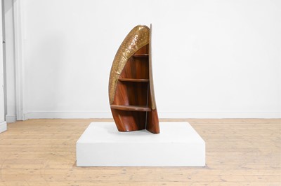 Lot 553 - A teak 'propeller' bookcase