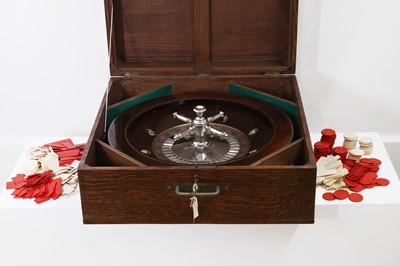 Lot 50 - A cased rosewood and brass-inlaid roulette wheel