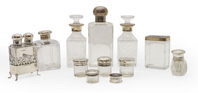 Lot 33 - A collection of silver topped bottles and dressing table items