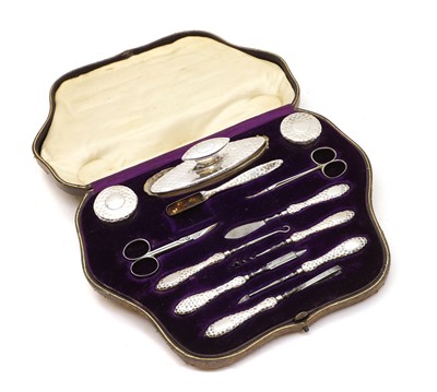 Lot 22 - A cased silver mounted manicure set