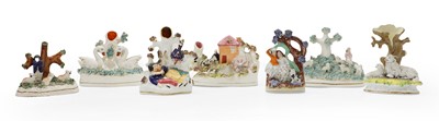 Lot 101 - A collection of Staffordhsire pottery flat back groups and taper stick holders