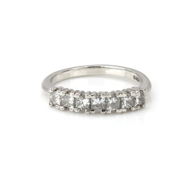 Lot 1049 - A platinum and diamond half eternity ring