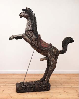 Lot 53 - A carved and polychrome painted wooden horse
