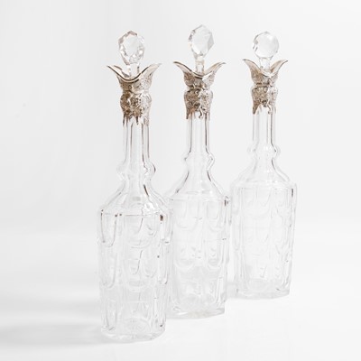 Lot 21 - A set of three silver-mounted cut-glass decanters