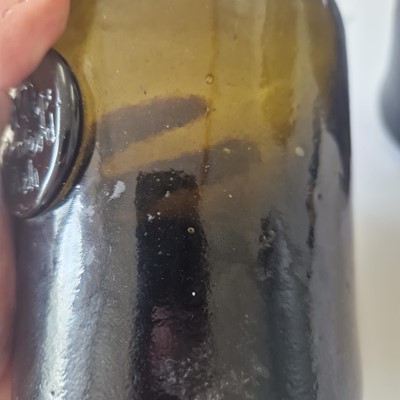 Lot 20 - A near pair of olive-green glass wine bottles