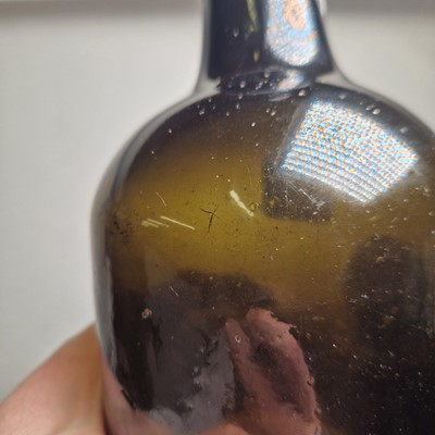 Lot 20 - A near pair of olive-green glass wine bottles